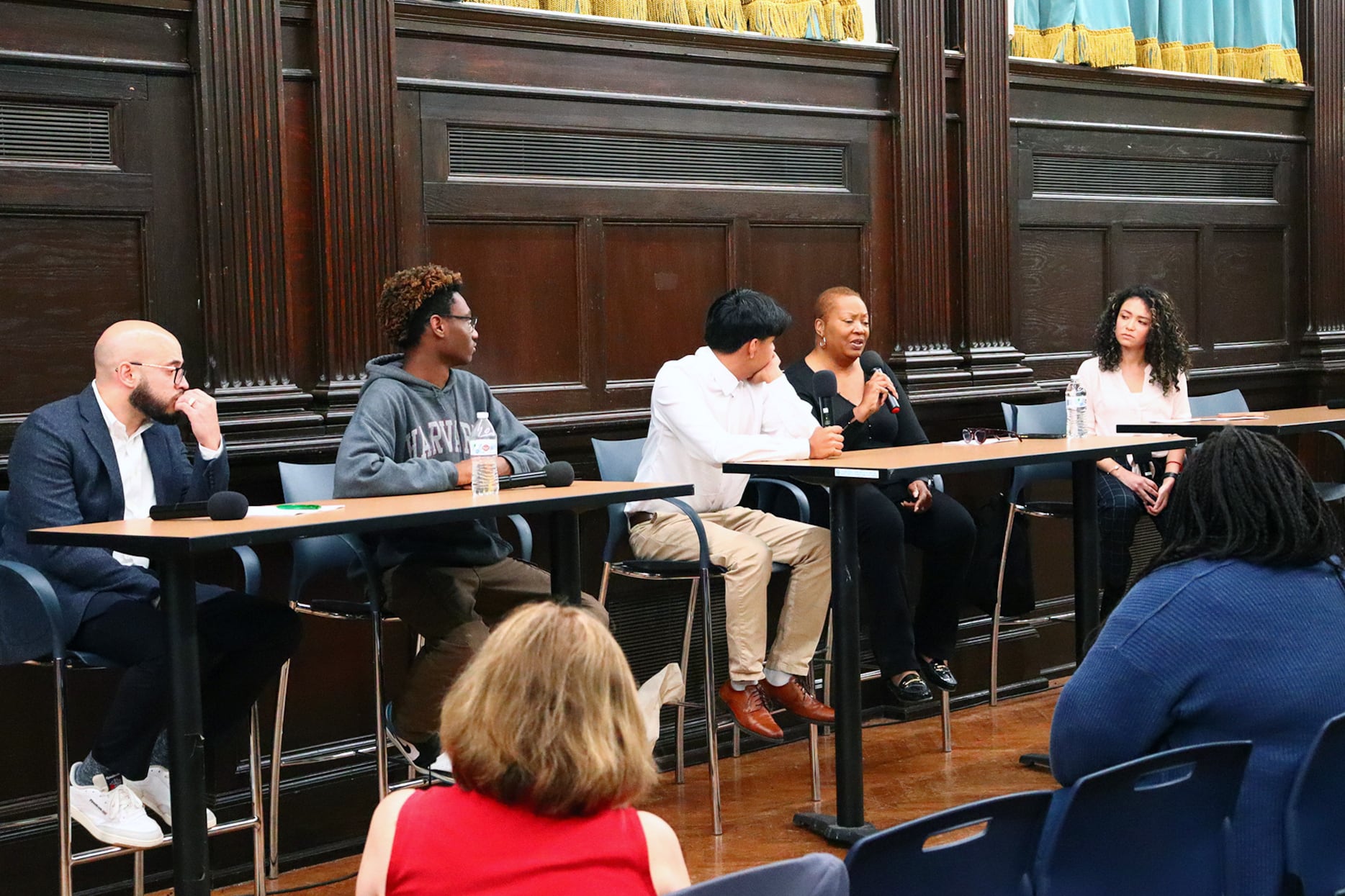 A group of panelists sits at a table.