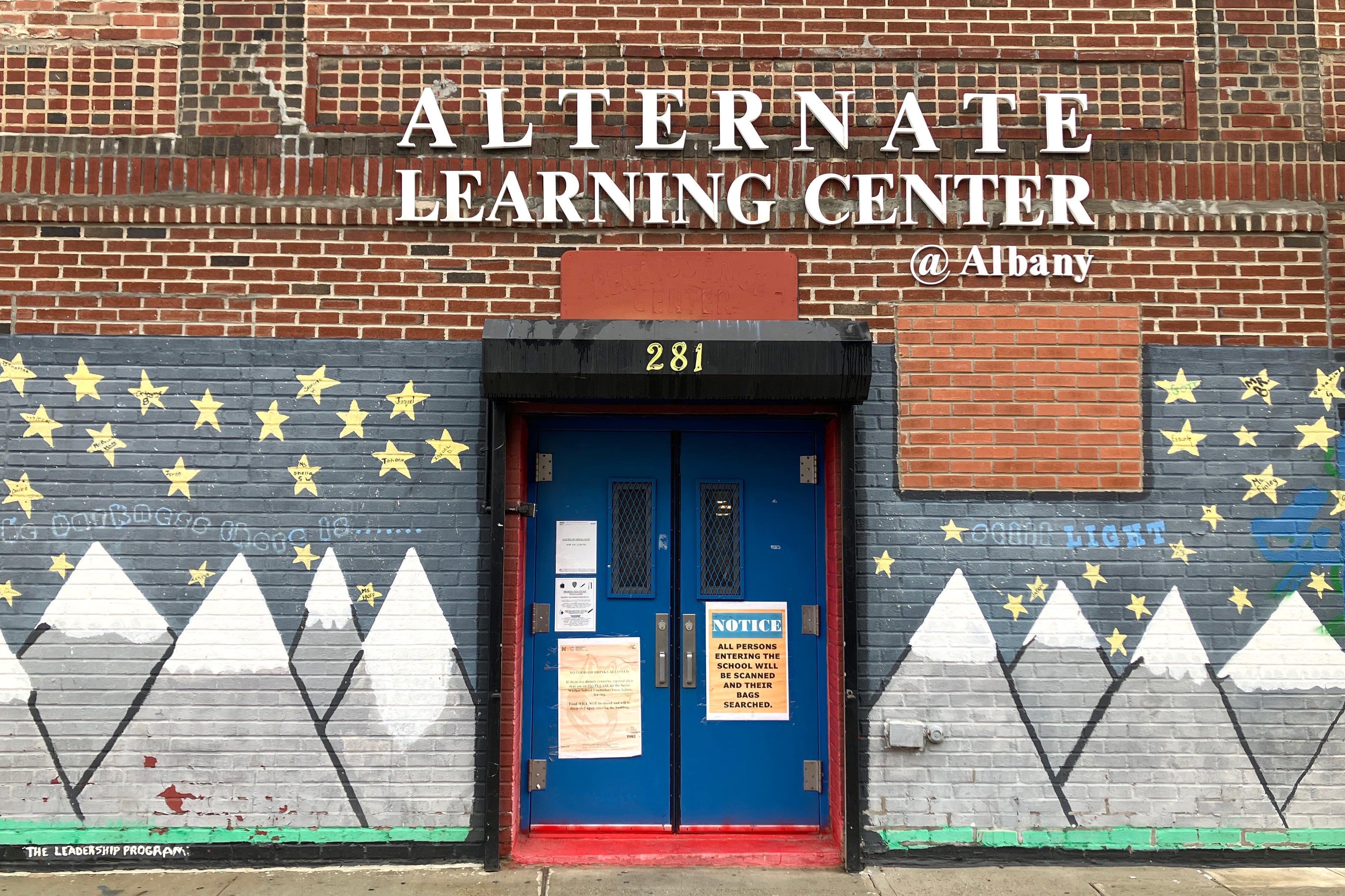 The front entrance of a brick building.