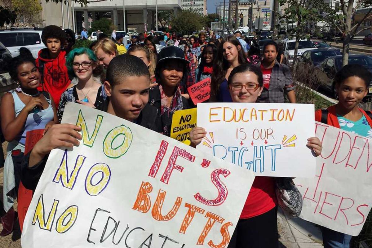 Students holding signs at a protest.
