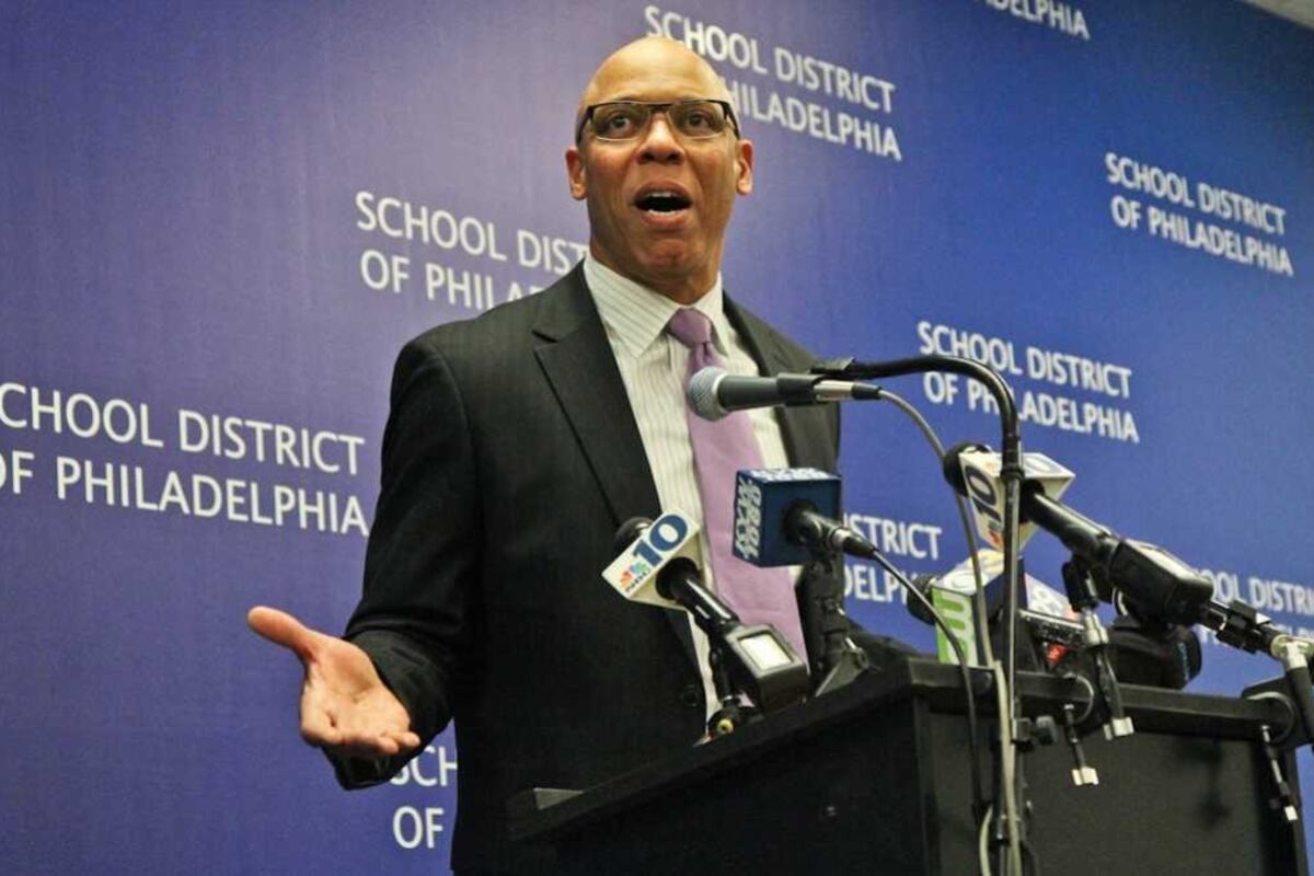 Philadelphia Superintendent William Hite stands at a podium surrounded by microphones.