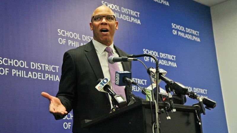 Philadelphia Superintendent William Hite stands at a podium surrounded by microphones.