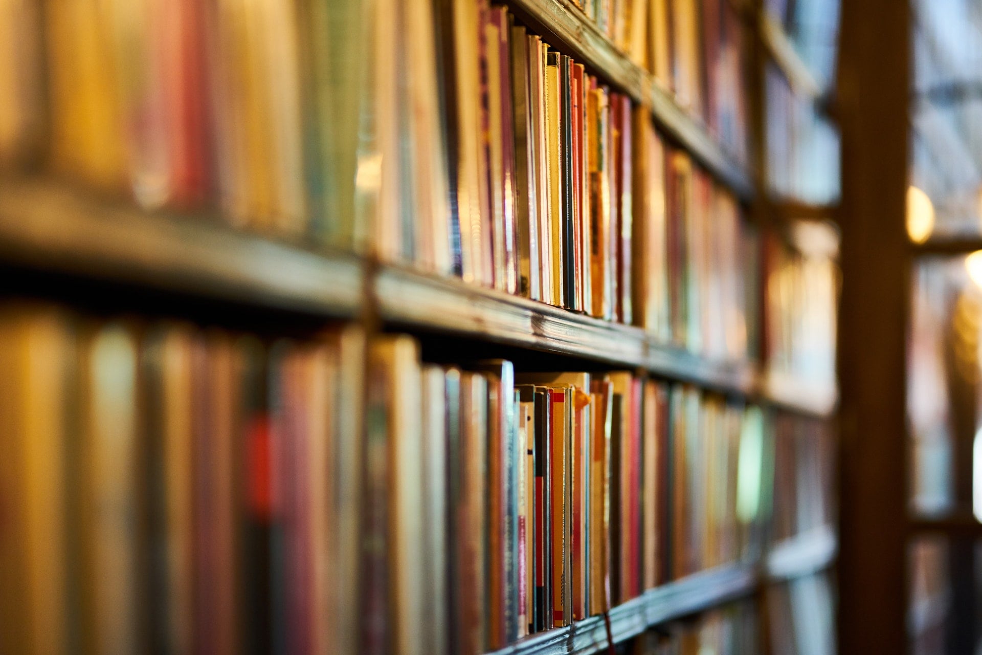 Close-up of books on shelves in a library.