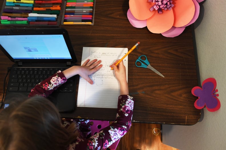 A student works on classwork in her room in Denver.