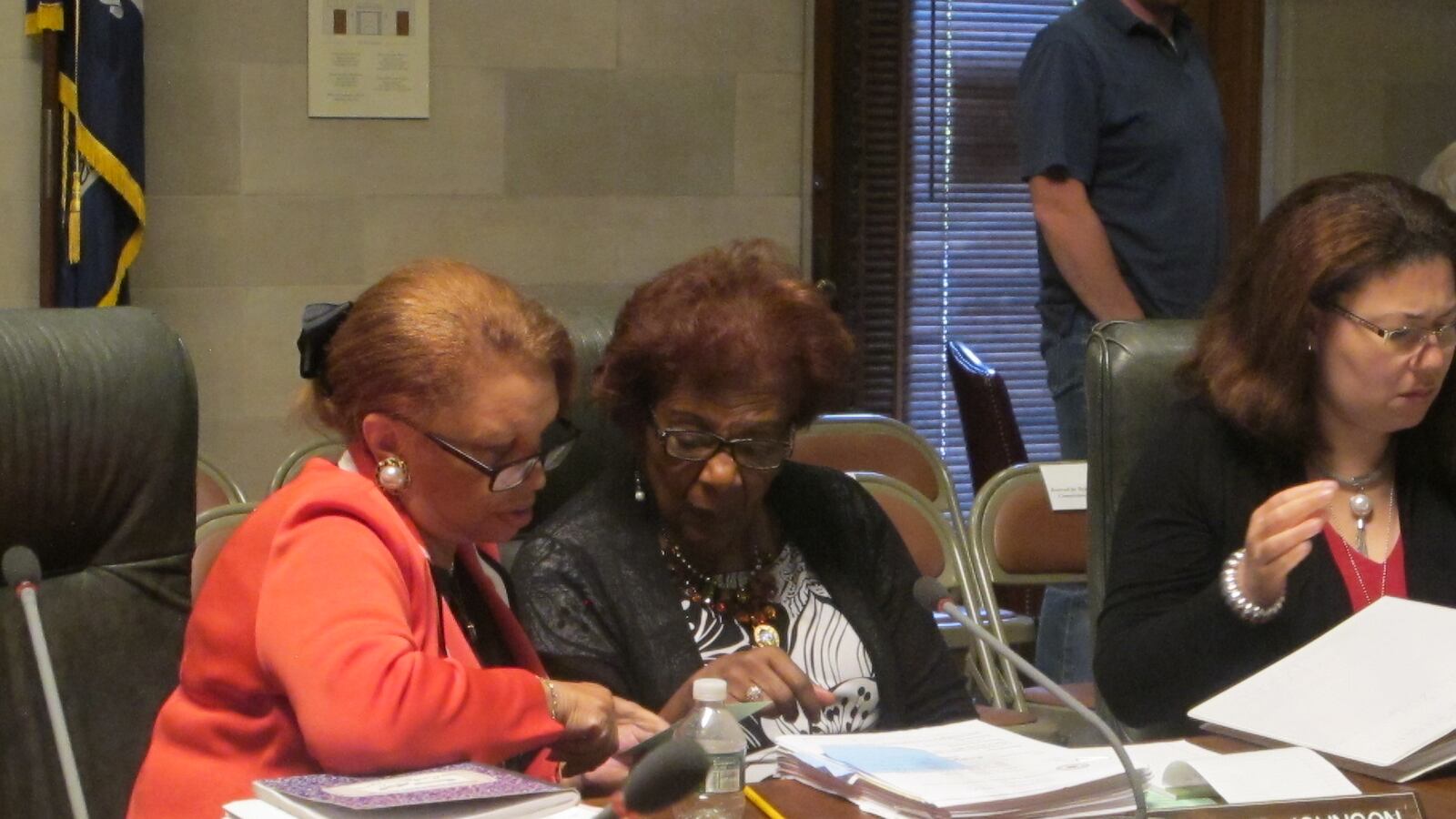 Regent Collins and Regent Johnson engage in a discussion after a Board of Regents meeting in 2016.