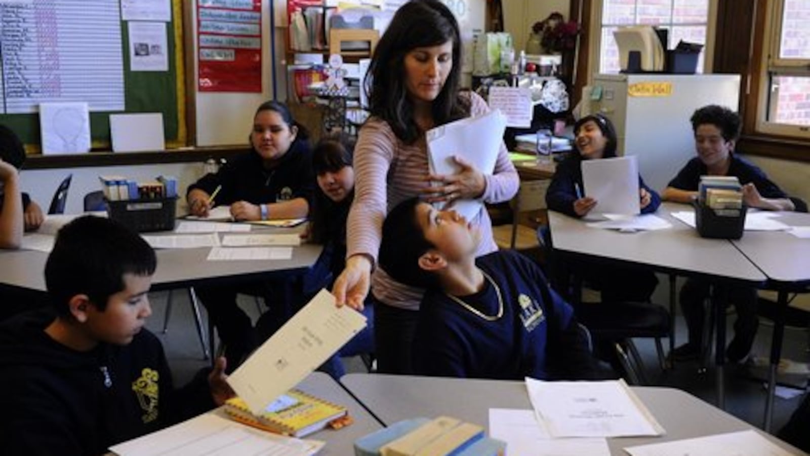 A teacher returns test scores to her class at Lake International School in Denver in 2012.